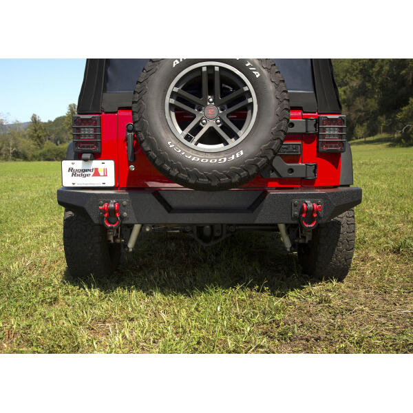 The Rugged Ridge Full Width Rear Bumper is the perfect complement to a Spartan Front Bumper on your Jeep Wrangler JK. This one piece design gives you a rugged off road look without hitting you hard in the wallet. The sturdy steel construction with welded ends will take whatever the outdoors throw at it while the center section features a recess to give you plenty of clearance to fit a larger spare tire if you are running larger tires on your JK. The integrated shackle plates are anchored to the frame giving you a solid recovery point if you every need to be pulled out of a sticky situation. - Image 2